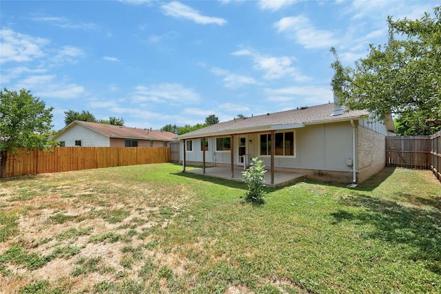 back of property featuring a patio area and a lawn