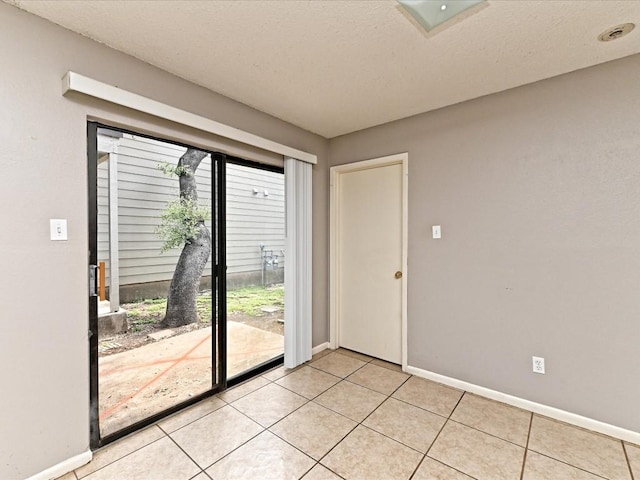 entryway with light tile patterned flooring