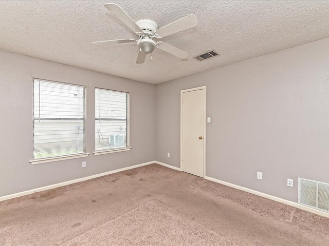 unfurnished room featuring ceiling fan, carpet flooring, and a textured ceiling