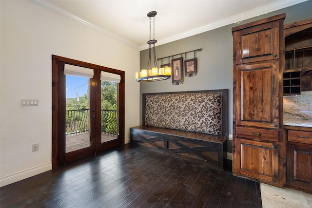 doorway with wood-type flooring, crown molding, french doors, and an inviting chandelier