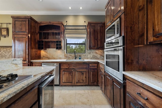 201 Cowal Dr N, Spicewood, TX 78669 - kitchen with stainless steel appliances, a sink, beverage cooler, ornamental molding, and backsplash