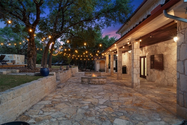 patio terrace at dusk featuring an outdoor fire pit