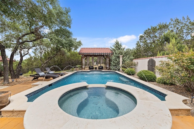 view of pool featuring an in ground hot tub, a gazebo, and pool water feature