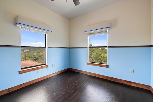 spare room featuring hardwood / wood-style flooring, ceiling fan, and plenty of natural light