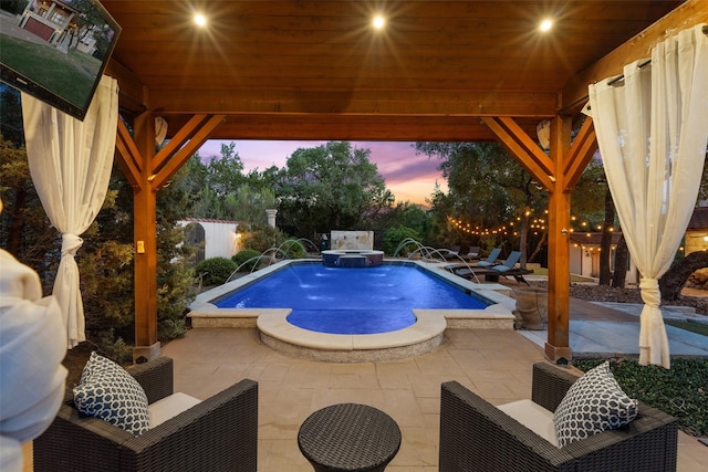 pool at dusk with an in ground hot tub, a patio area, a gazebo, and pool water feature