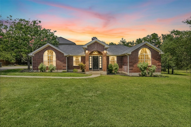 single story home featuring french doors and a lawn