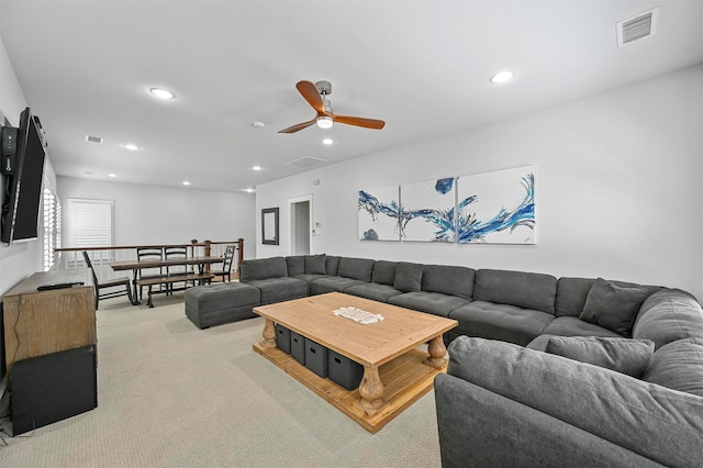 carpeted living room featuring ceiling fan