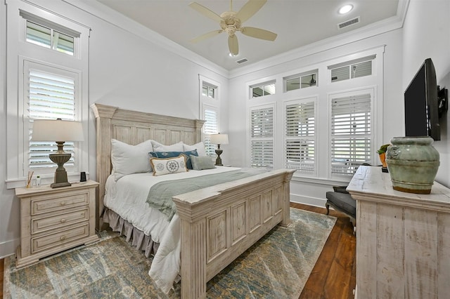 bedroom with dark wood-type flooring, ceiling fan, and crown molding