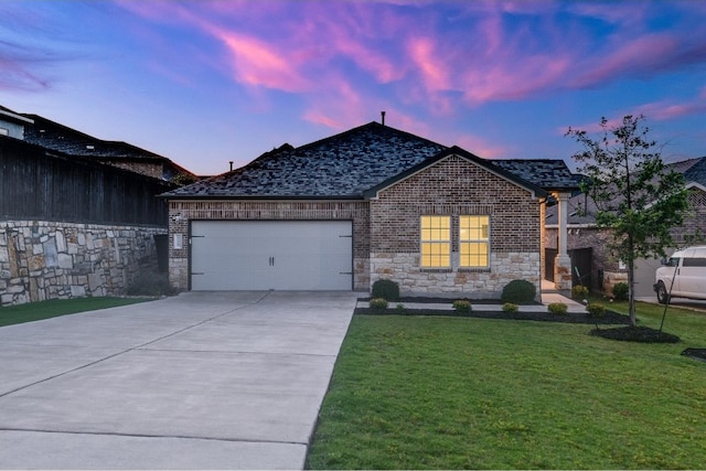 view of front of house featuring a garage and a yard