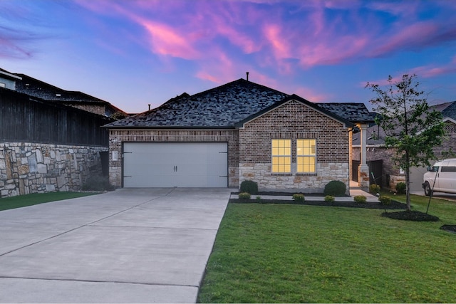 view of front facade with a lawn and a garage