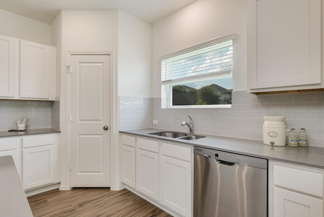 kitchen with white cabinets, dishwasher, tasteful backsplash, sink, and light wood-type flooring