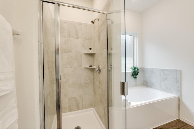 bathroom featuring wood-type flooring and independent shower and bath