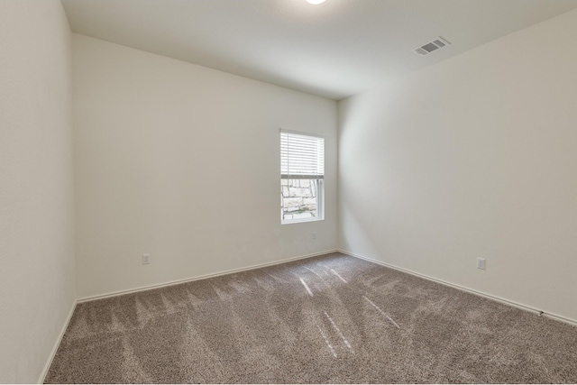 empty room featuring dark colored carpet