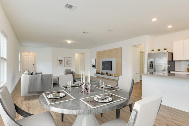 dining area with light hardwood / wood-style floors