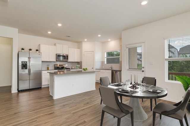 dining room featuring sink and hardwood / wood-style flooring