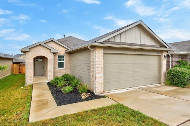 view of front of house featuring a garage and a front lawn