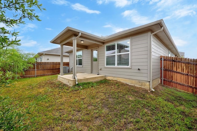 back of house featuring a yard and a patio