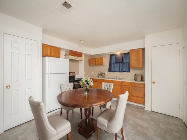 dining space with visible vents and light floors