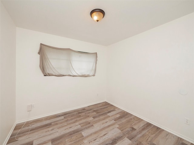 spare room featuring hardwood / wood-style floors