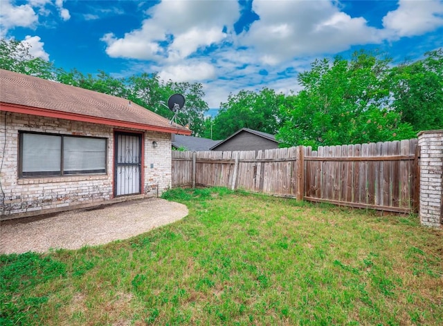 view of yard with a fenced backyard