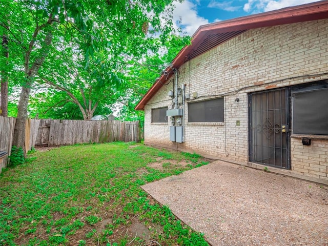 view of yard featuring a patio area and a fenced backyard