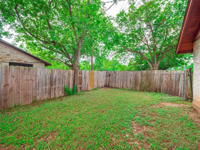 view of yard with a fenced backyard