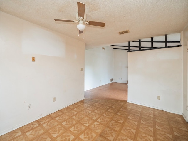 unfurnished room featuring a textured ceiling, ceiling fan, vaulted ceiling, and parquet flooring