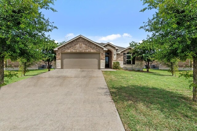 view of front of property featuring a garage and a front lawn