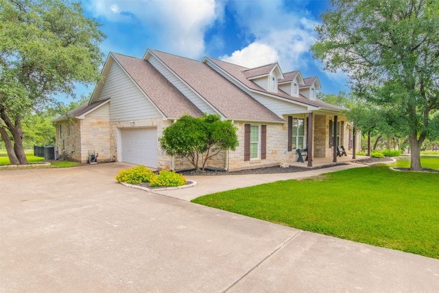 cape cod house with a garage, central air condition unit, and a front yard