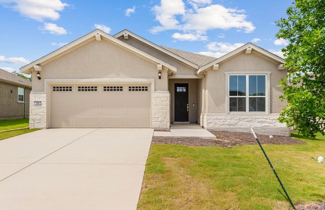 105 Riversong Cv, Georgetown, TX 78633 - view of front facade featuring stone siding, stucco siding, concrete driveway, a garage, and a front yard