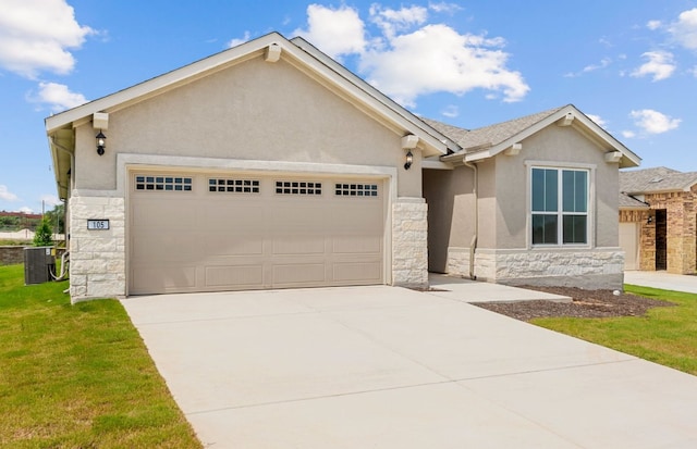 105 Riversong Cv, Georgetown, TX 78633 - view of front of home featuring stone siding, stucco siding, an attached garage, and driveway