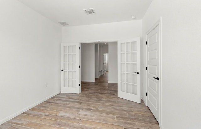 105 Riversong Cv, Georgetown, TX 78633 - empty room with french doors, light wood finished floors, and baseboards