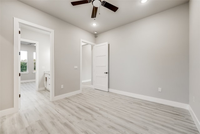 unfurnished bedroom featuring ensuite bathroom, ceiling fan, and light wood-type flooring