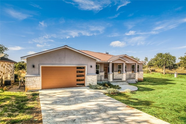 view of front of home featuring covered porch, central air condition unit, a garage, and a front yard