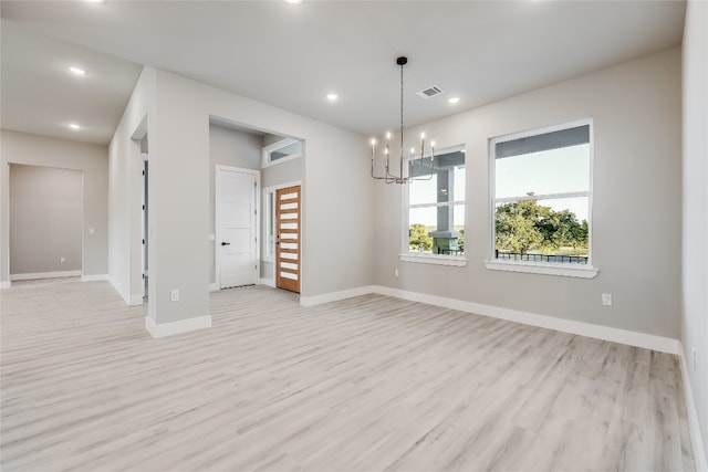 interior space with an inviting chandelier and light wood-type flooring