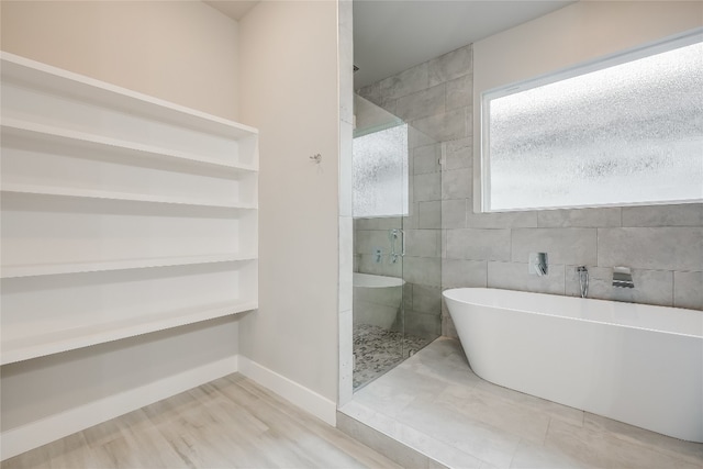 bathroom with tile patterned floors and separate shower and tub