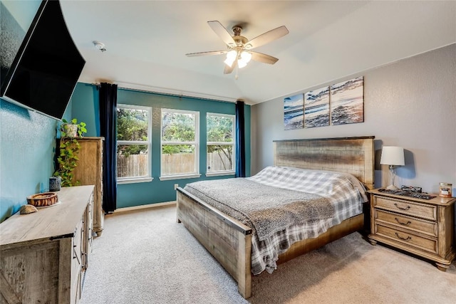 bedroom featuring light carpet and ceiling fan