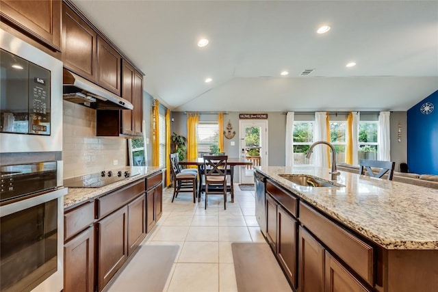 20400 Bear Rd, Lago Vista, TX 78645 - kitchen featuring a sink, stainless steel appliances, under cabinet range hood, light tile patterned floors, and backsplash