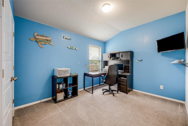 carpeted office space with vaulted ceiling