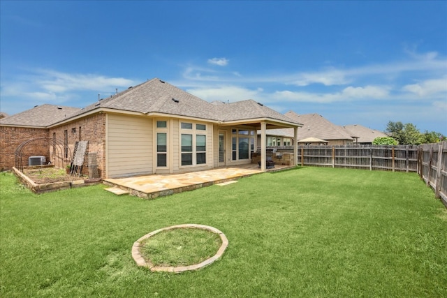 rear view of property featuring a yard, a patio area, and central AC unit