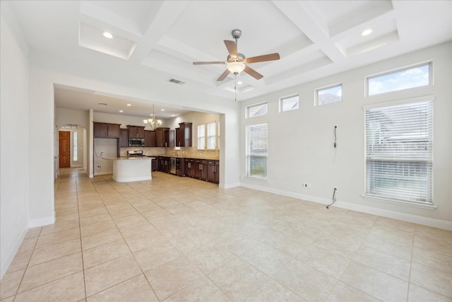 unfurnished living room featuring beam ceiling, ceiling fan with notable chandelier, coffered ceiling, and light tile patterned floors