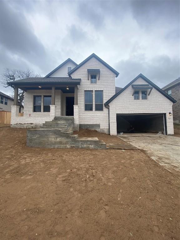 view of front facade with a garage and covered porch