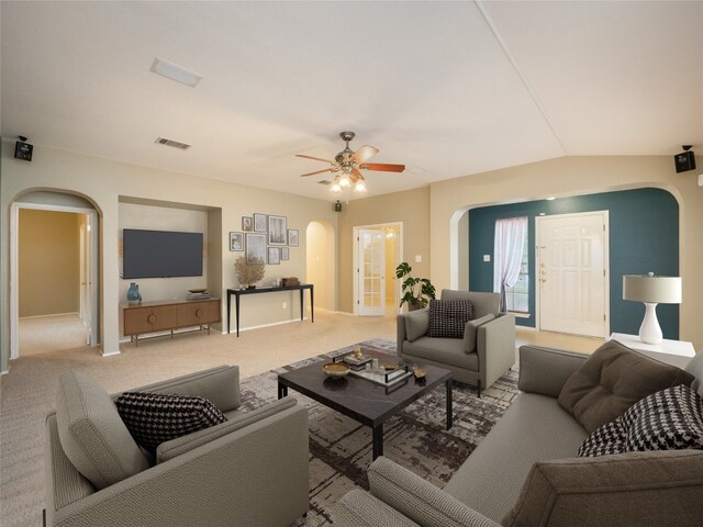 carpeted living room with vaulted ceiling and ceiling fan