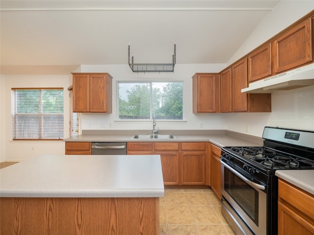 kitchen with a healthy amount of sunlight, vaulted ceiling, appliances with stainless steel finishes, and sink