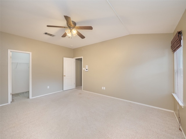 carpeted empty room with ceiling fan and lofted ceiling