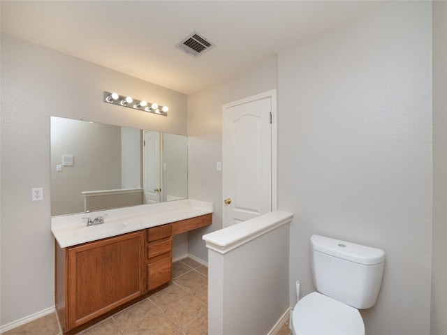 bathroom featuring tile patterned floors, vanity, and toilet