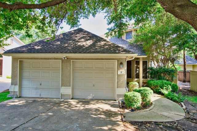 6 Muirfield Greens Cv, Lakeway, TX 78738 - view of front facade featuring a shingled roof, an attached garage, and stucco siding
