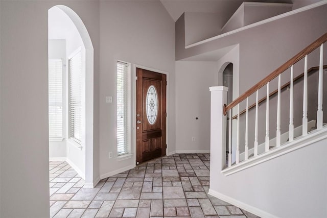 entryway featuring a towering ceiling