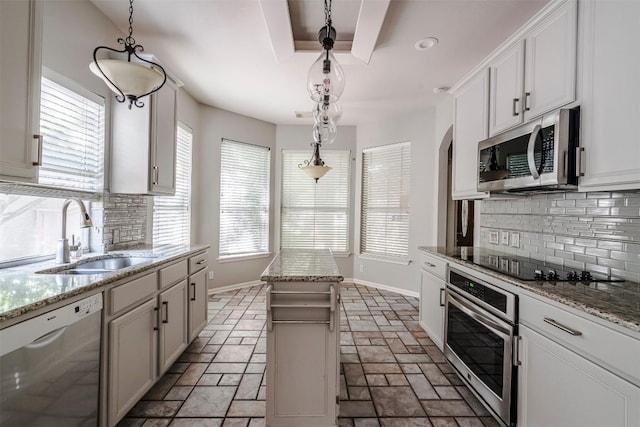 kitchen with stainless steel appliances, white cabinetry, hanging light fixtures, and sink