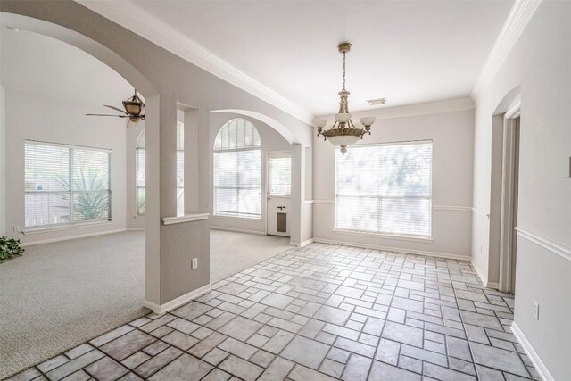 6 Muirfield Greens Cv, Lakeway, TX 78738 - unfurnished dining area with a chandelier, a ceiling fan, arched walkways, baseboards, and ornamental molding